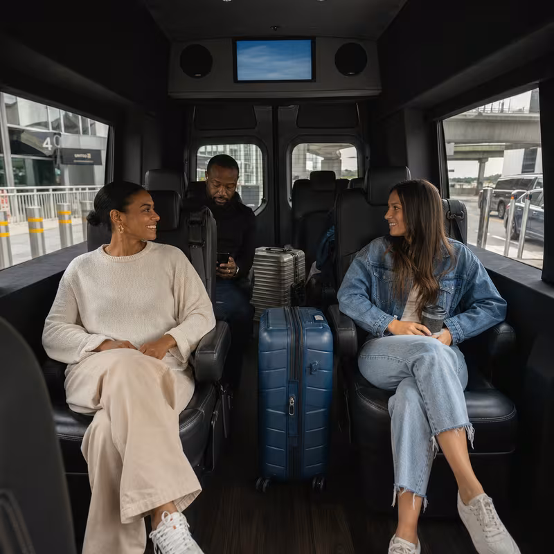 Passengers loading luggage while boarding an New Orleans group shuttle