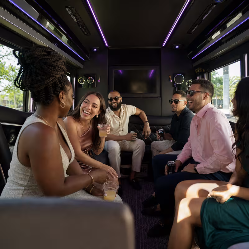 Party bus interior with wraparound leather seating and LED lighting in New Orleans