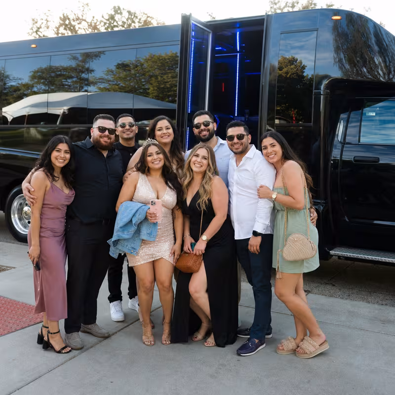 Group boarding a white charter bus for Birthday Transportation transportation in New Orleans