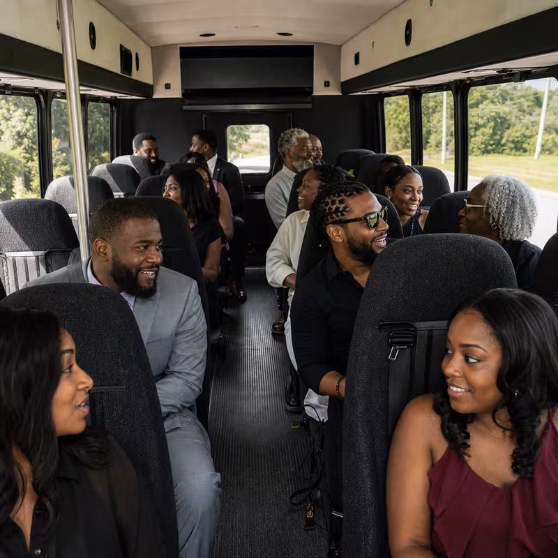 Group boarding a white charter bus for Private Event Transportation transportation in New Orleans