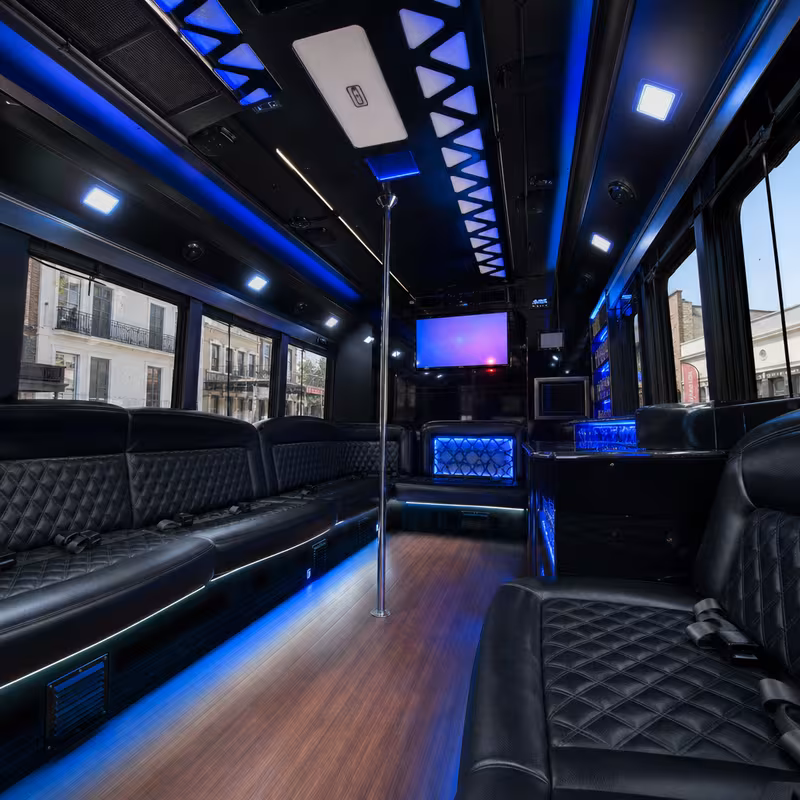 Party bus interior with wraparound leather seating and LED lighting in New Orleans