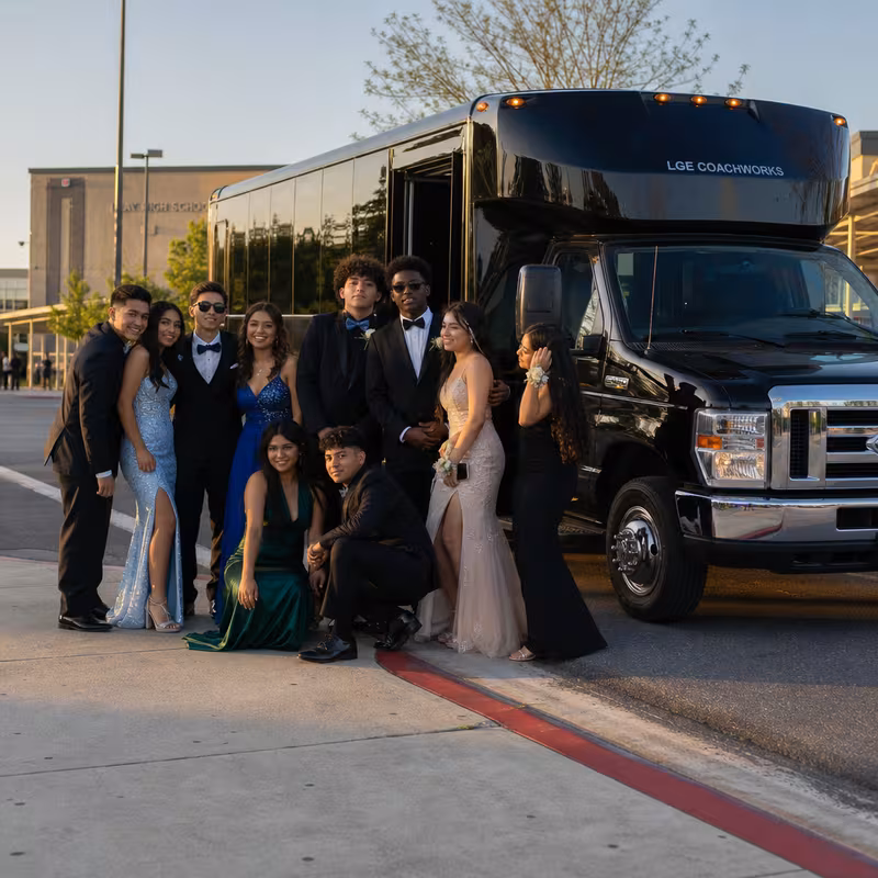 Group boarding a white charter bus for Prom & Homecoming Transportation transportation in New Orleans