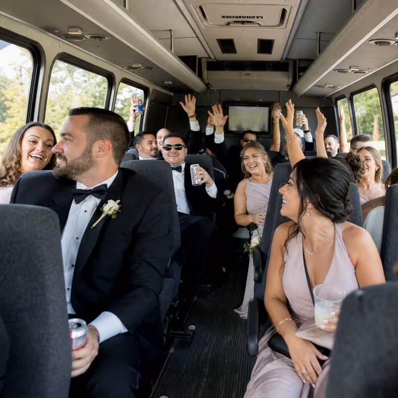 Group boarding a white charter bus for Wedding Transportation transportation in New Orleans