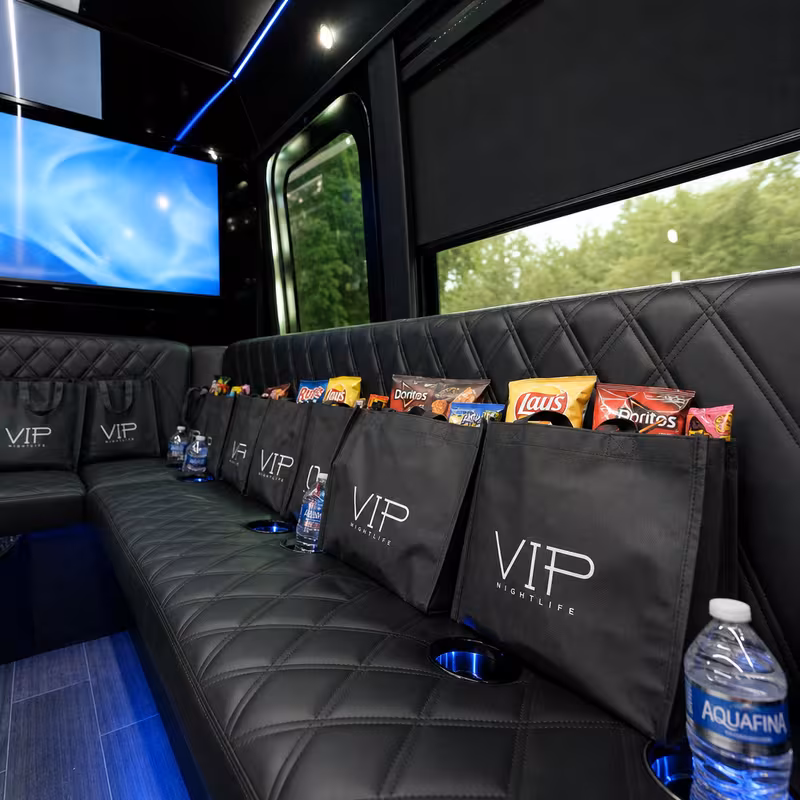 Party bus interior with wraparound leather seating and LED lighting in New Orleans